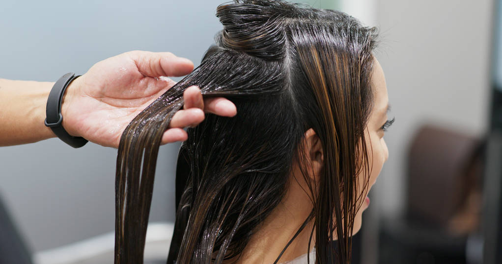 Woman having hair treatment